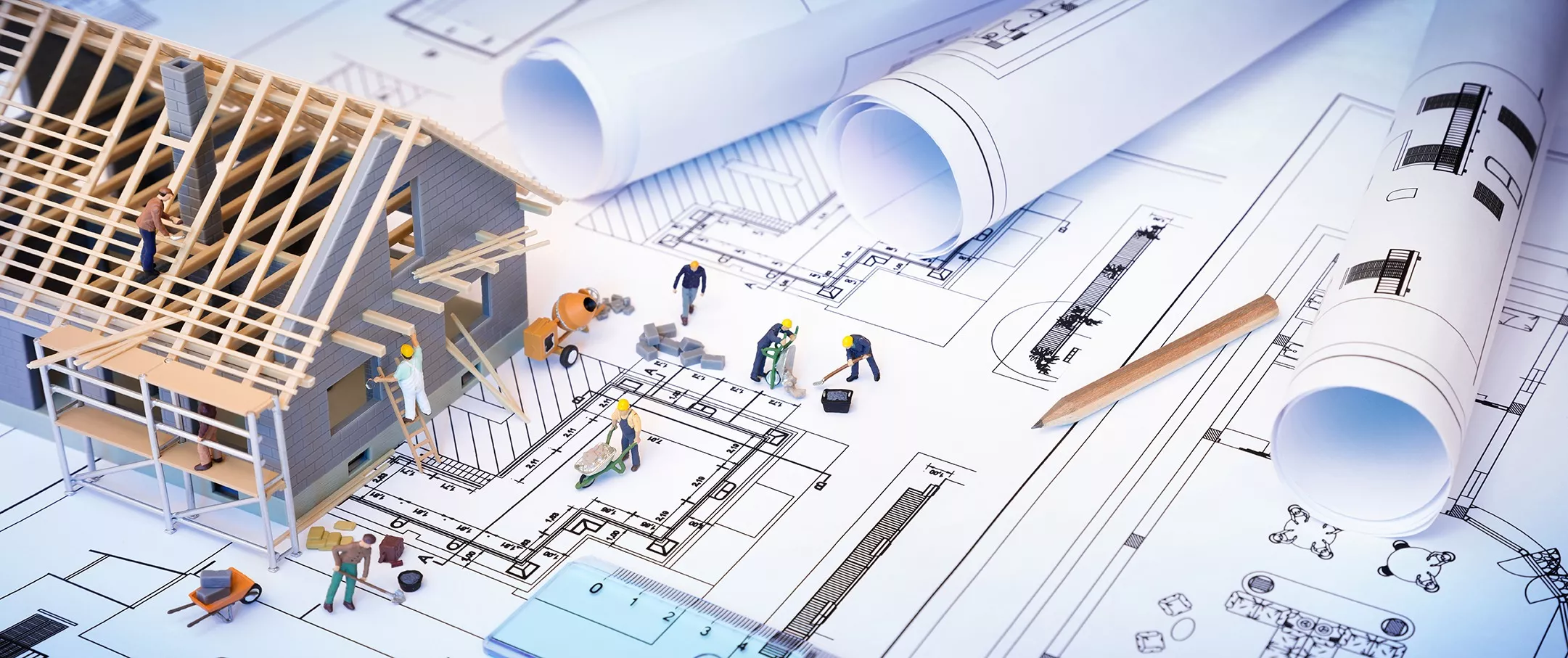 house under construction on blueprints - building project